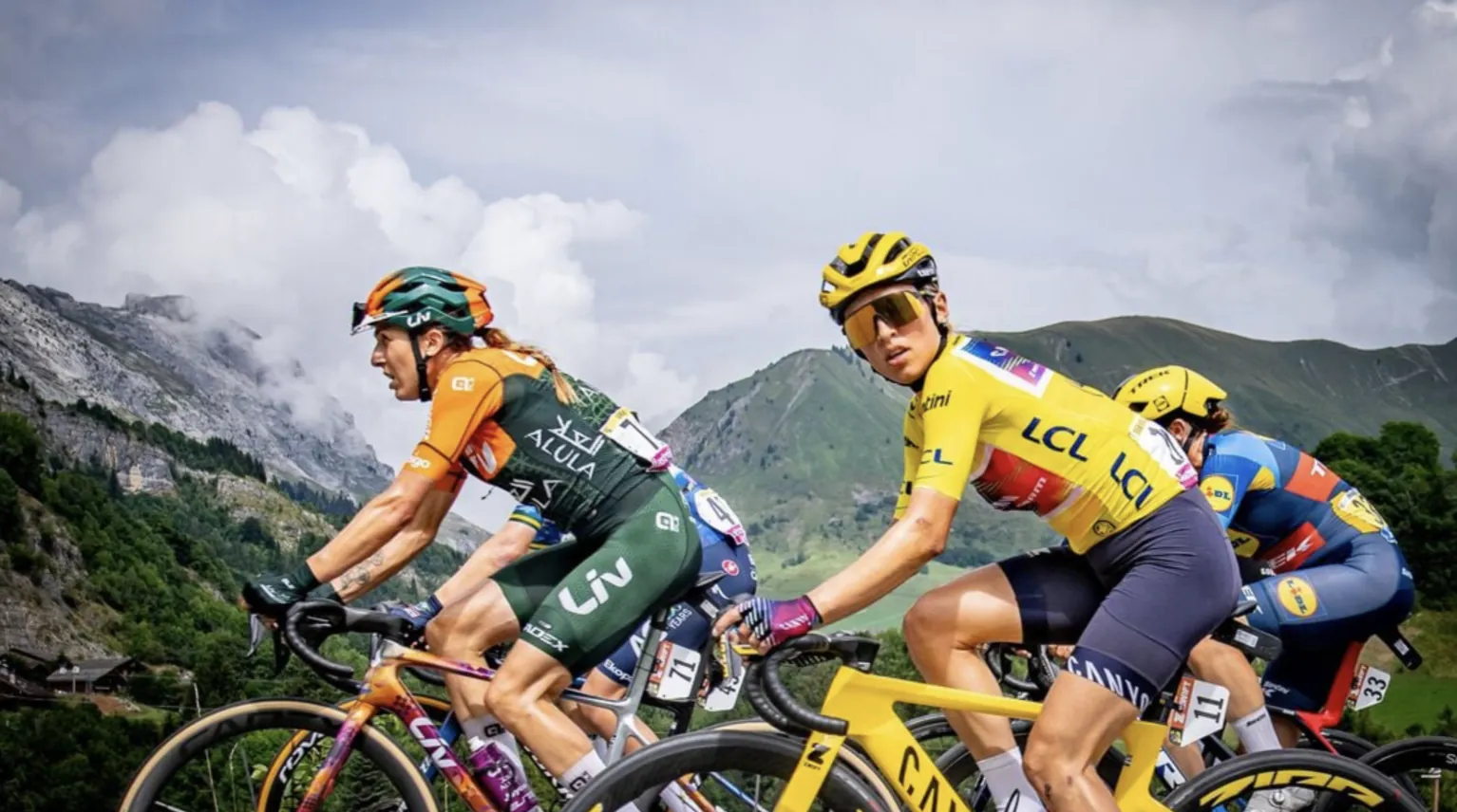 Riders in the leader's yellow jersey climbing through the mountains